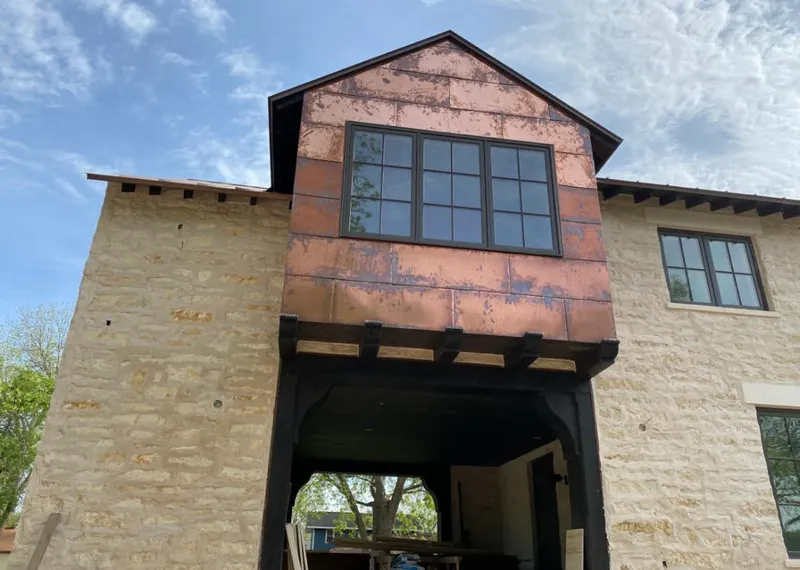 Copper metal panel facade on a stone building for Skylight Installation in Woodbury